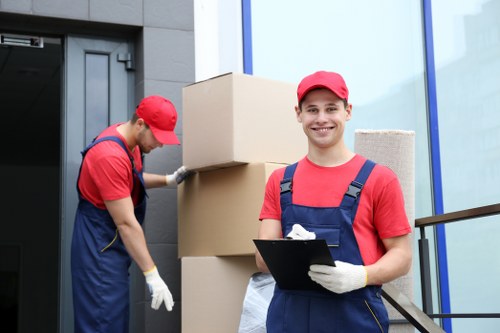 Removal team preparing a van load with safety checks