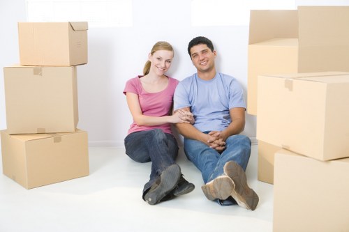 Furniture and boxes being prepared for transport by a local moving truck