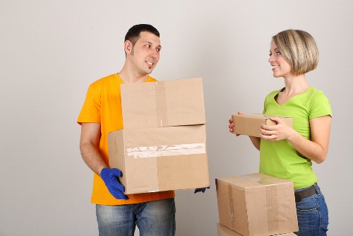 Local movers navigating stairs in a Shepherds Bush apartment building